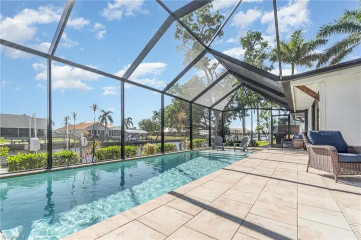 Outdoor pool featuring enclosed lanai