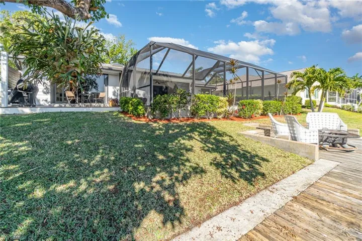 View of yard with pool enclosure and a fire pit