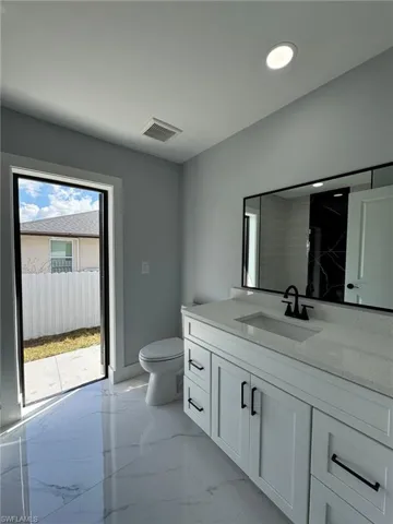 Bathroom featuring vanity and toilet