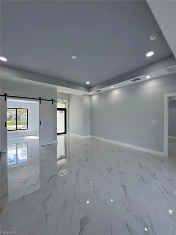 Unfurnished room with a barn door