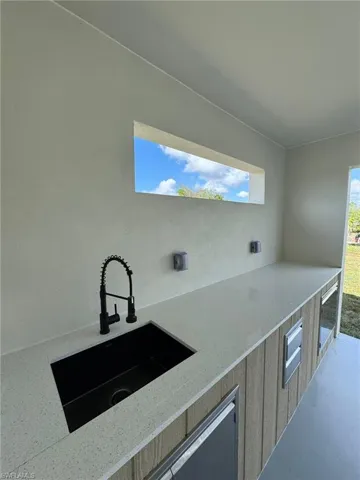 View of patio / terrace featuring sink and beverage cooler