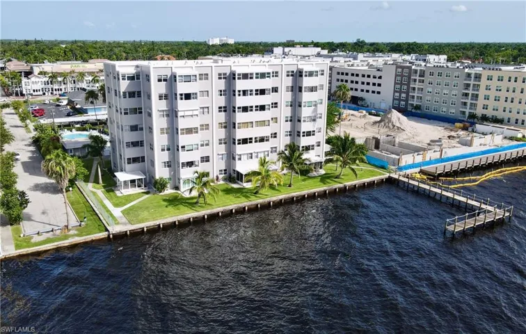 Birds eye view of property with a water view