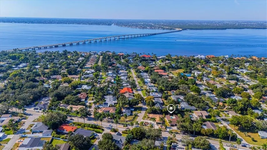 Aerial view of residential area with a notable bridge and a nearby body of water