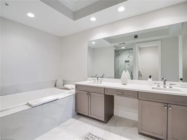Bathroom featuring plus walk in shower and vanity