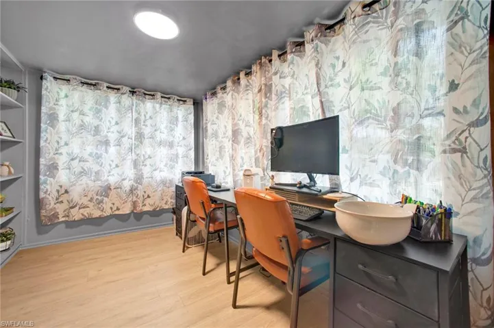 Office space with light wood-style flooring