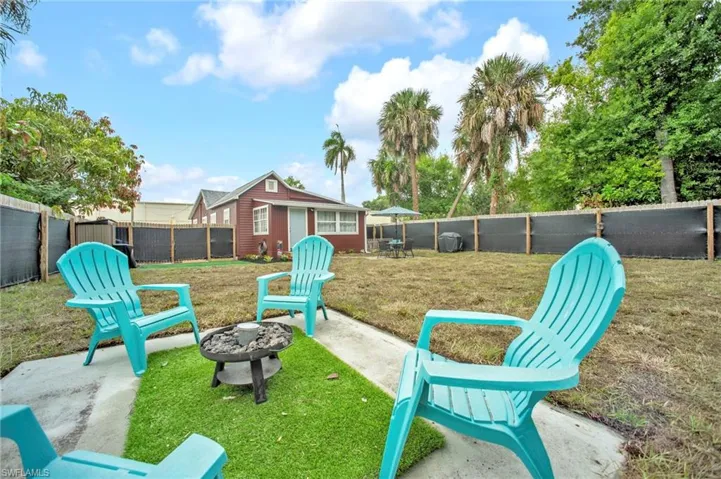 View of yard with a fire pit and an outbuilding