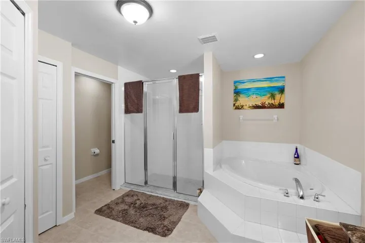 Bathroom featuring tile floors and separate shower and tub
