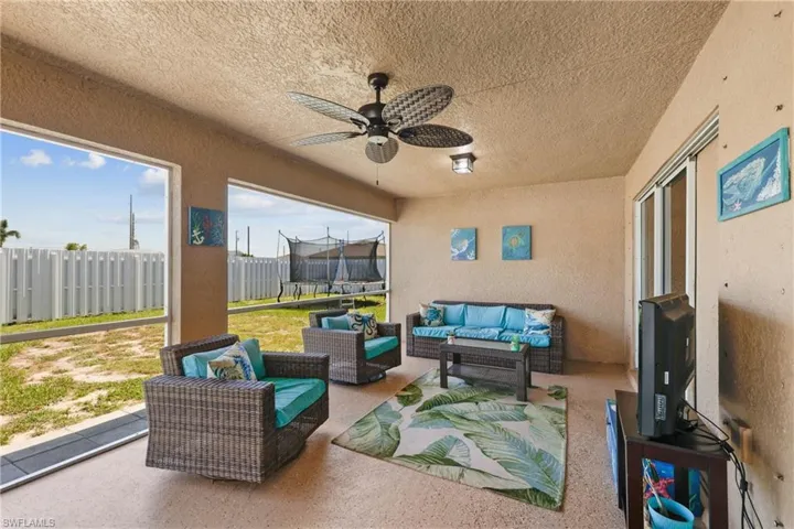 Sunroom featuring a wealth of natural light and ceiling fan