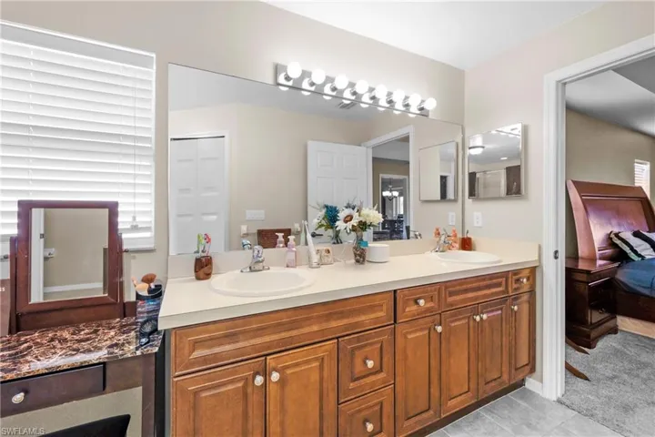 Bathroom with double sink vanity and tile floors