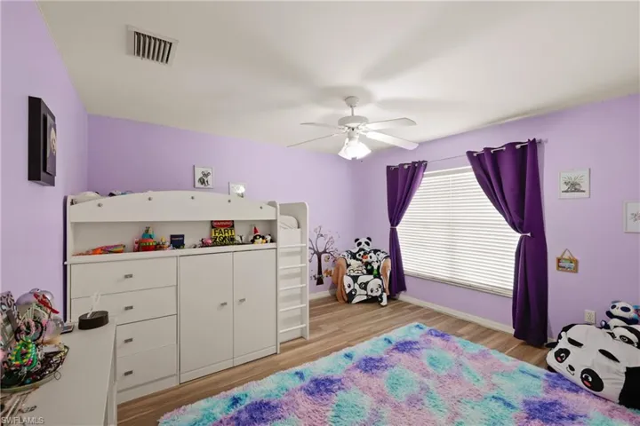 Bedroom with ceiling fan and light hardwood / wood-style floors
