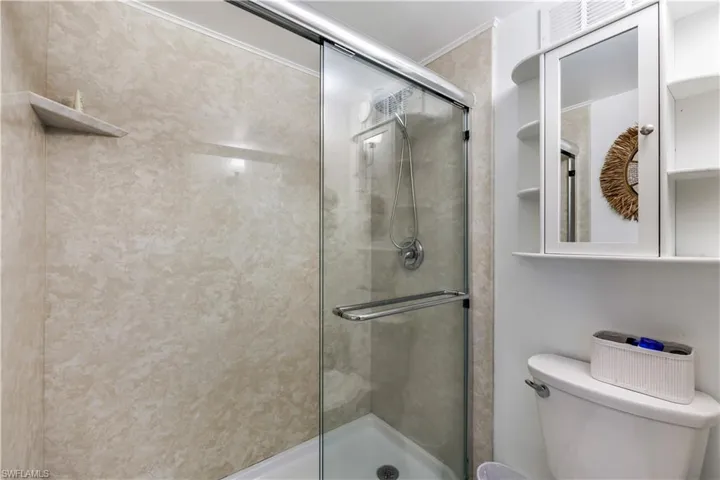 Bathroom featuring toilet and an enclosed shower