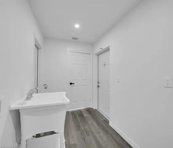 Bathroom with wood finished floors and recessed lighting