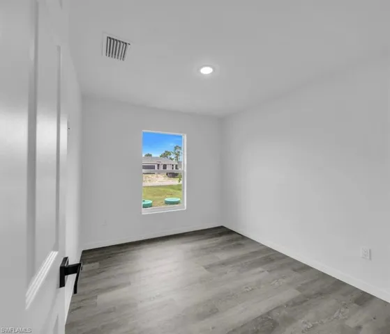 Empty room featuring light wood-style flooring and baseboards