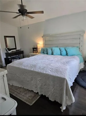Bedroom with ceiling fan and dark wood-type flooring