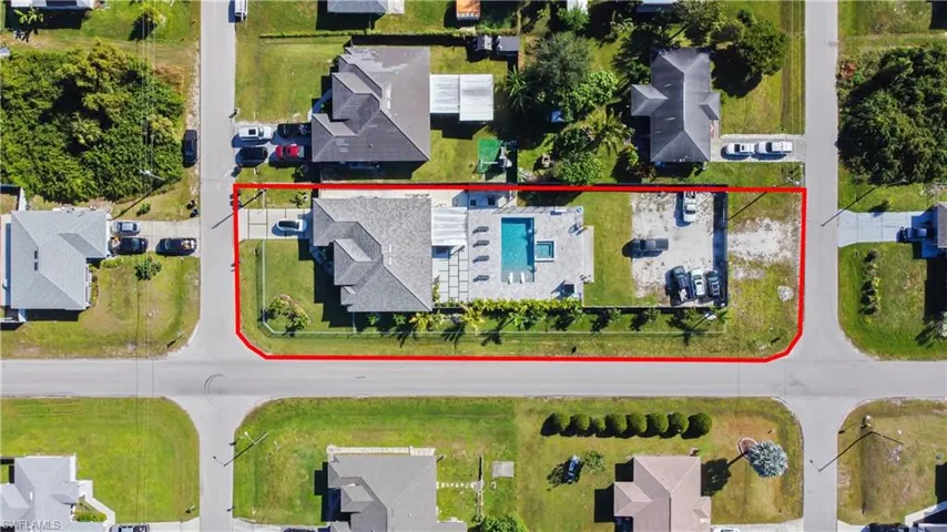 Aerial view of residential area featuring property boundaries highlighted