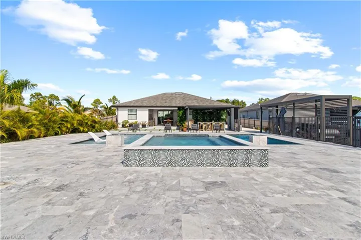 View of swimming pool featuring a patio area and a pool with connected hot tub