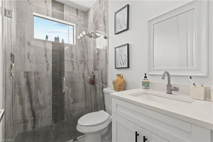 Full bathroom with vanity and a marble finish shower