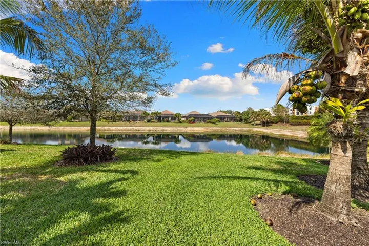 View of green lawn featuring a water view
