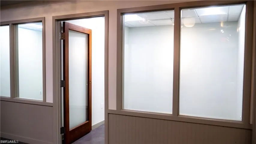 Hallway featuring a drop ceiling