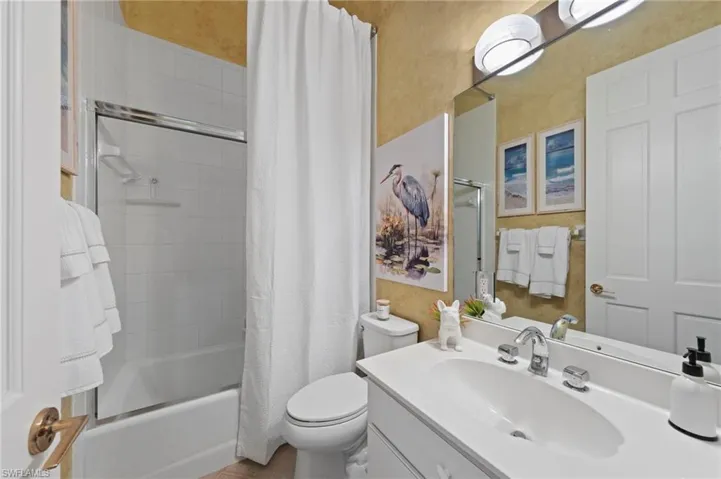 Main House Guest Bathroom with vanity and shower / bath combination with curtain