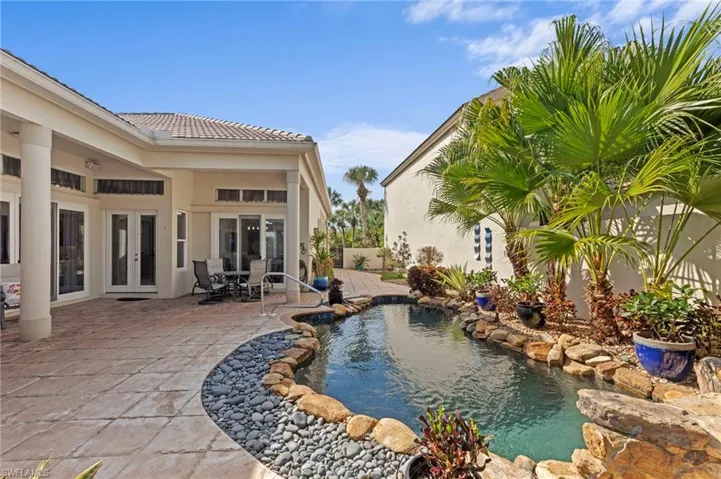 Outdoor pool with french doors, a patio area, and outdoor dining area