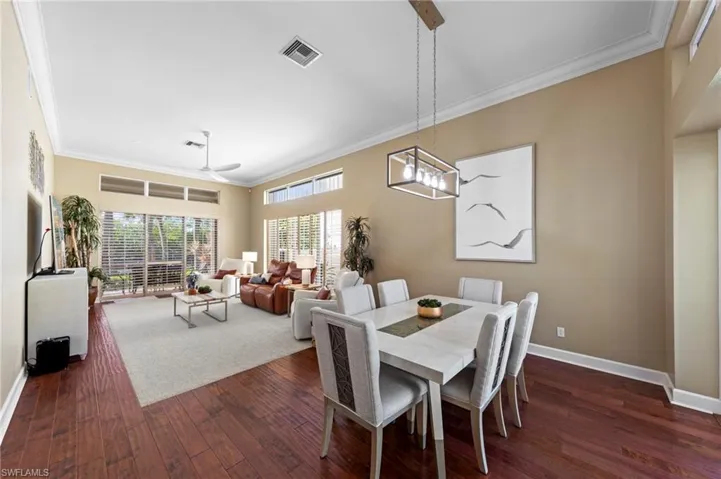 Dining space featuring ornamental molding, dark wood finished floors, and ceiling fan
