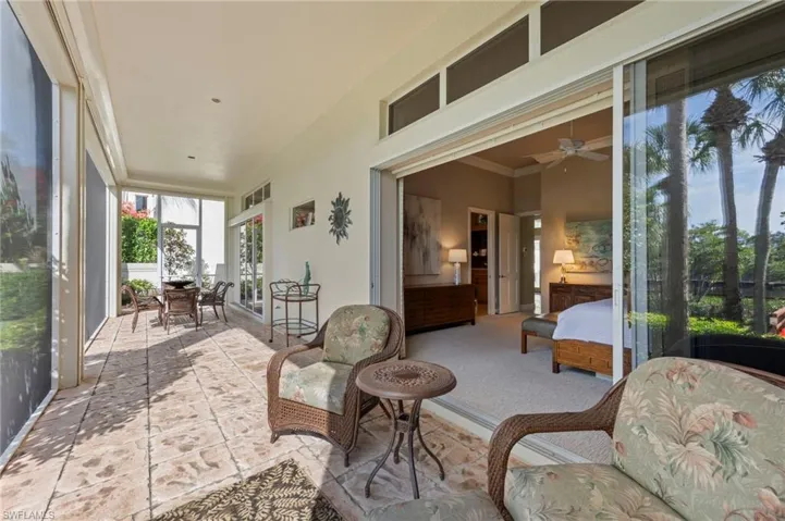 Screened lanai with crown molding, a ceiling fan, and outdoor dining area