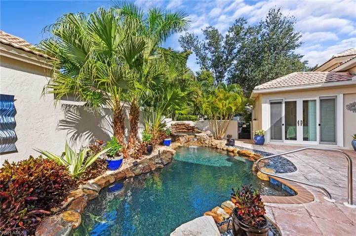 View of courtyard pool with a fenced yard, french doors to guest cabana, and a patio area