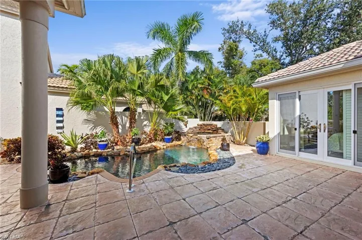 Courtyard with french doors to guest cabana and a patio