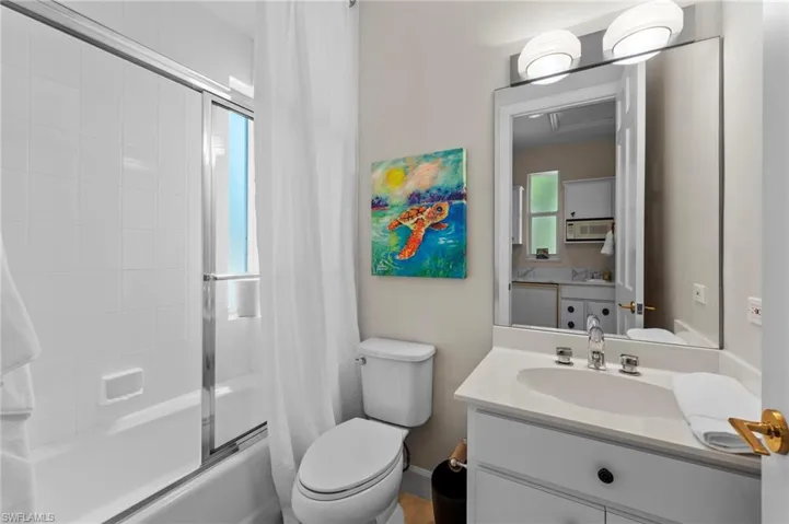 Full Guest bath with shower / bath combination with glass door and vanity