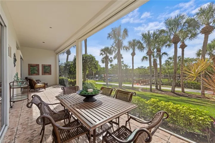 View of rear screened patio / terrace with outdoor dining area and view of the river