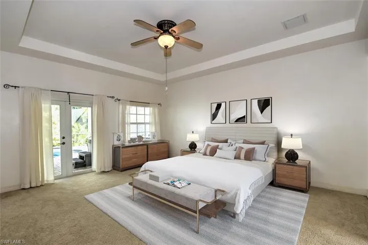 Primary Bedroom with French Doors to Screened Pool Area
