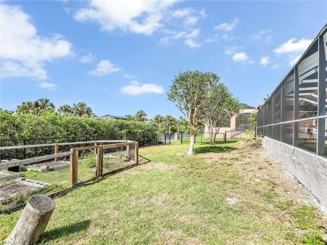 View of fenced yard with a garden