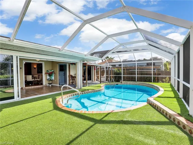 View of pool featuring glass enclosure