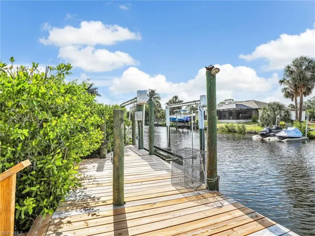Dock area with a water view and boat lift