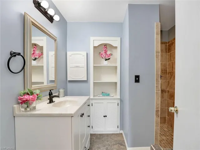 Bathroom with tiled shower and built-in.