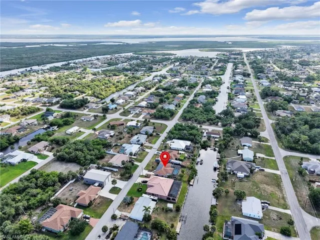 View of property location featuring a nearby body of water and nearby suburban area