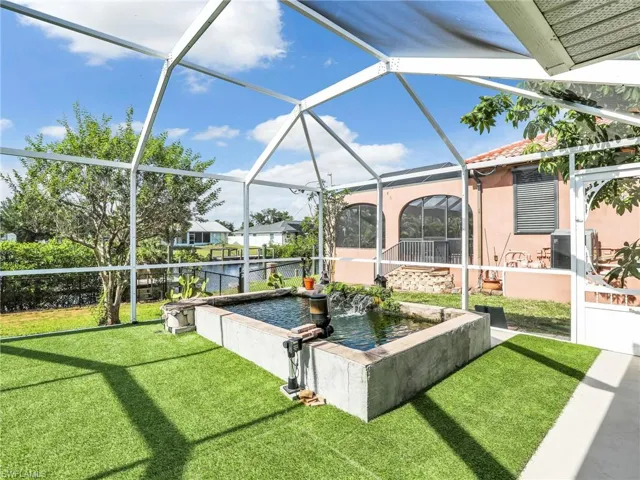 View of grassy pool area with Koi fish pond