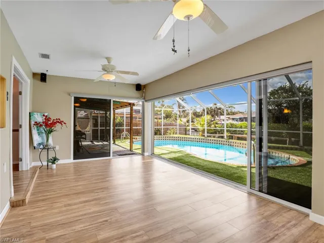 Unfurnished sunroom with a ceiling fan