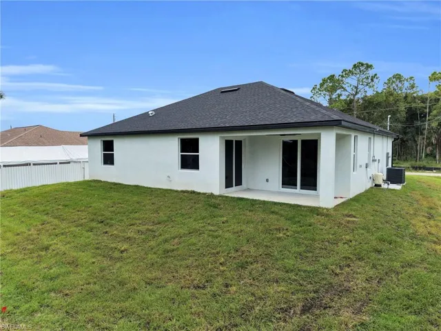 Rear exterior with lanai and sliding glass doors.