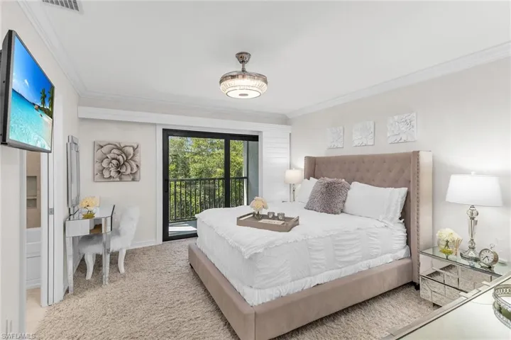Carpeted bedroom featuring access to exterior and ornamental molding