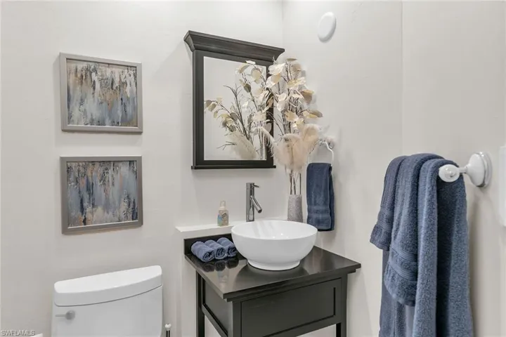 Half bathroom with vanity and toilet