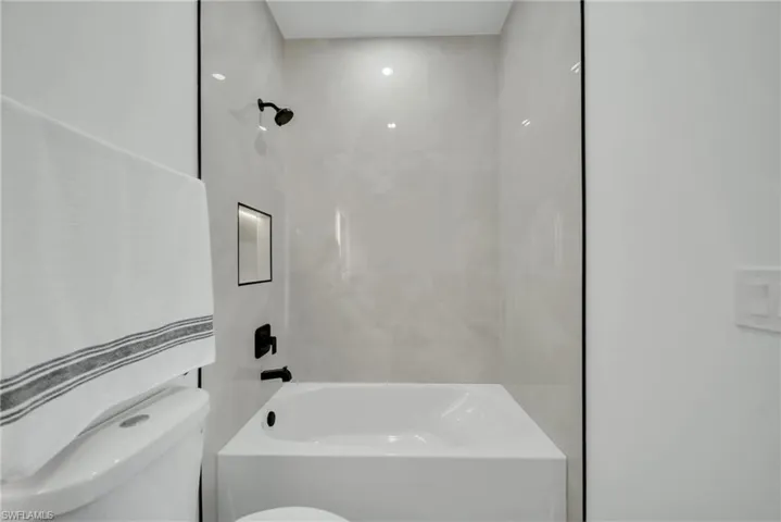Bathroom featuring  shower combination and toilet