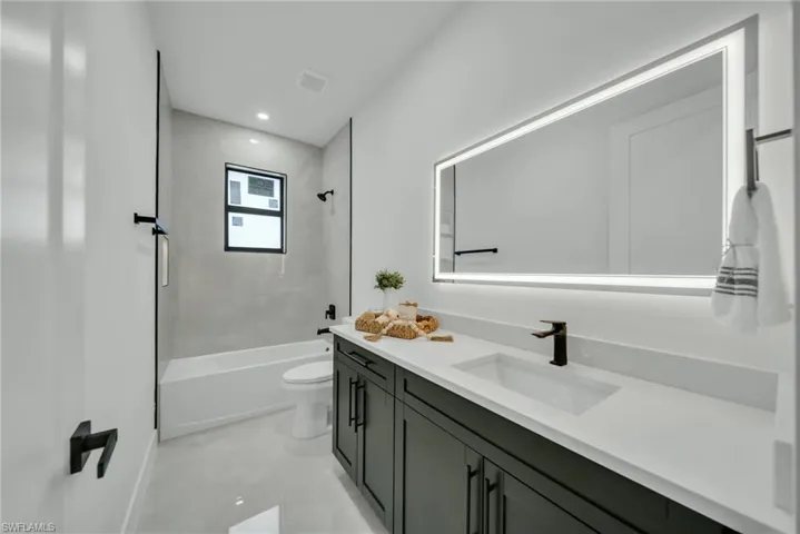 Full bathroom featuring vanity,  shower combination, and recessed lighting