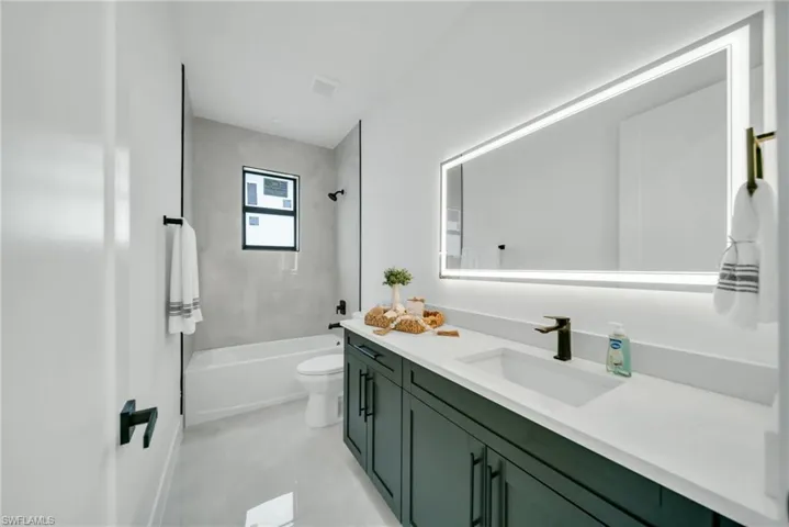 Bathroom with vanity and shower / washtub combination