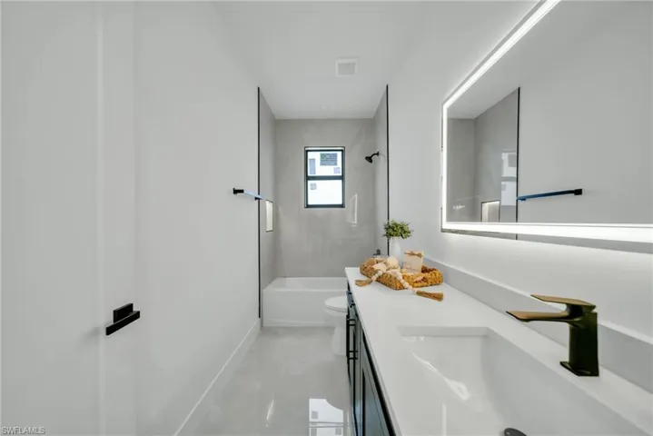 Bathroom featuring vanity and tub / shower combination