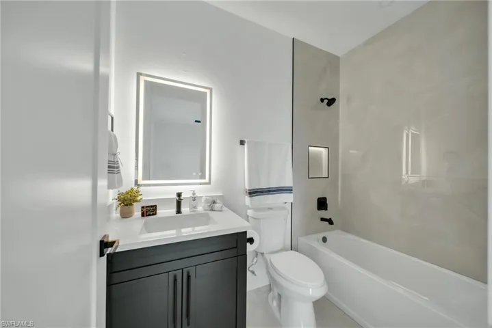 Full bathroom featuring vanity and tub / shower combination
