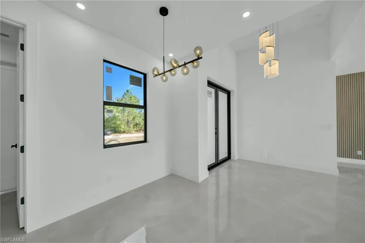 Unfurnished dining area featuring finished concrete floors and recessed lighting