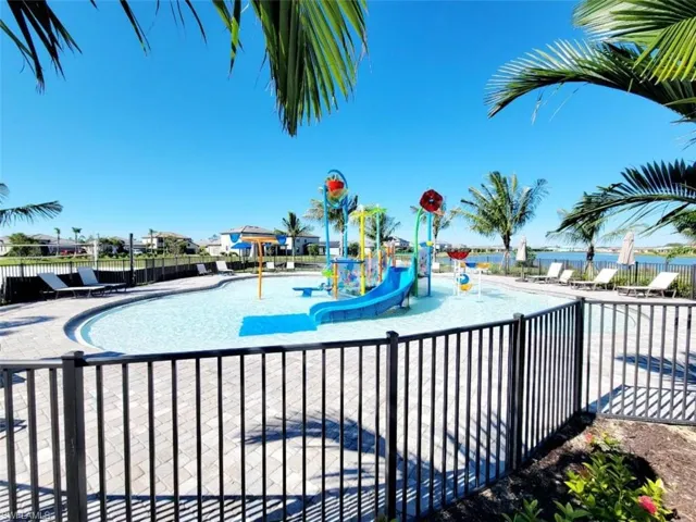 Community pool with a water play area and a patio