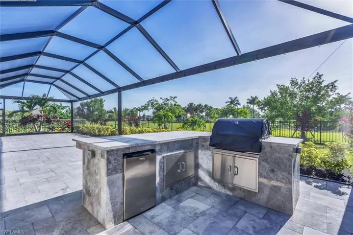 View of patio / terrace with an outdoor kitchen and glass enclosure